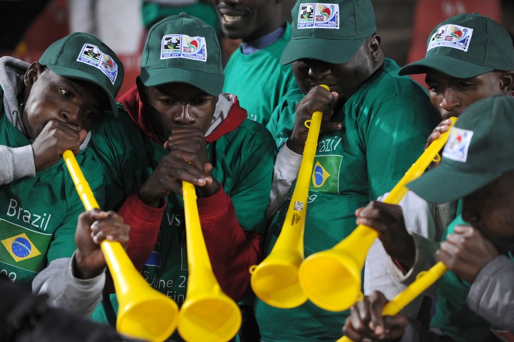 Supporters play the vuvuzela, large colo