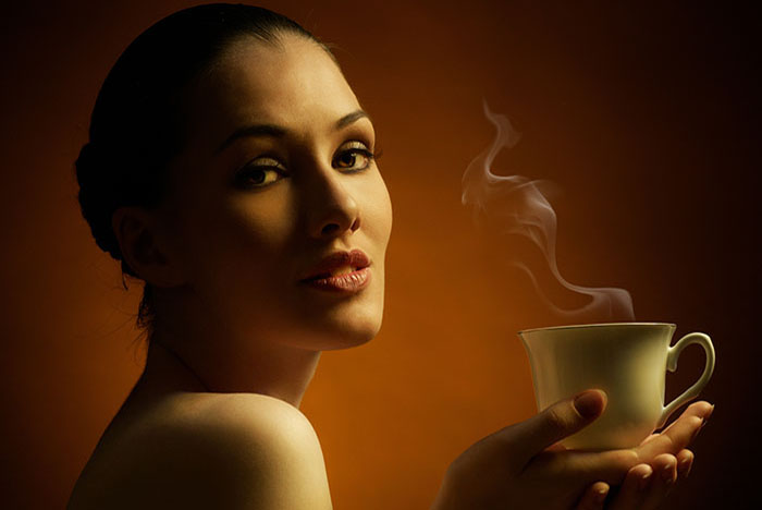 Woman with an aromatic coffee in hands